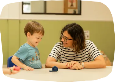 Teacher helping a student develop language skills