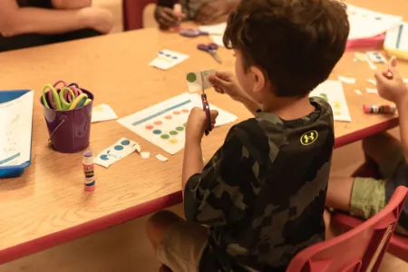 Boy working on a writing activity at a table