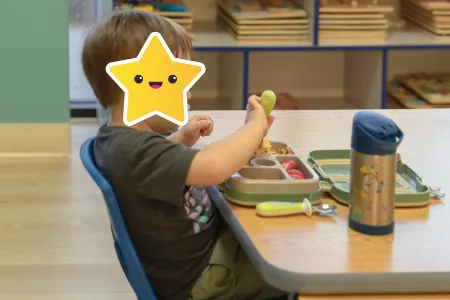 Child working on an activity at a classroom table
