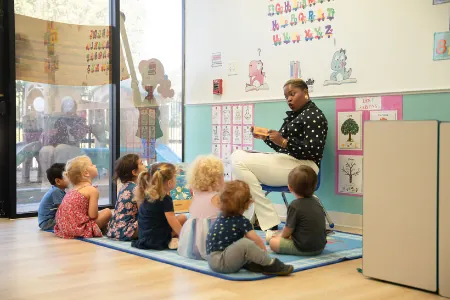 Teacher leading circle time with children on the classroom rug