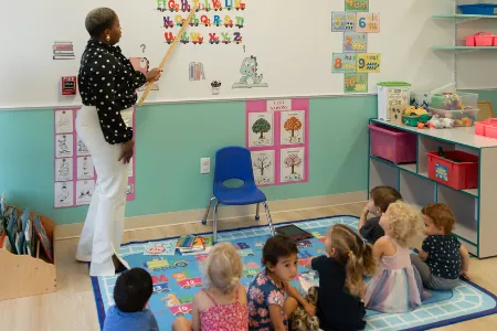 Teacher leading circle time with children on the classroom rug