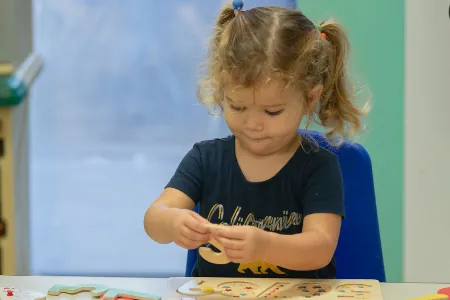 Toddler concentrating on a hands-on activity