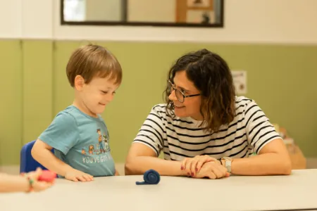 Teacher working one-on-one with a boy at a table