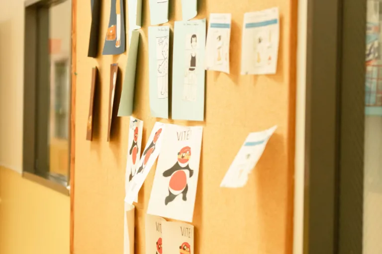Children's drawings pinned on a corkboard