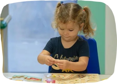 Preschooler practicing writing in French