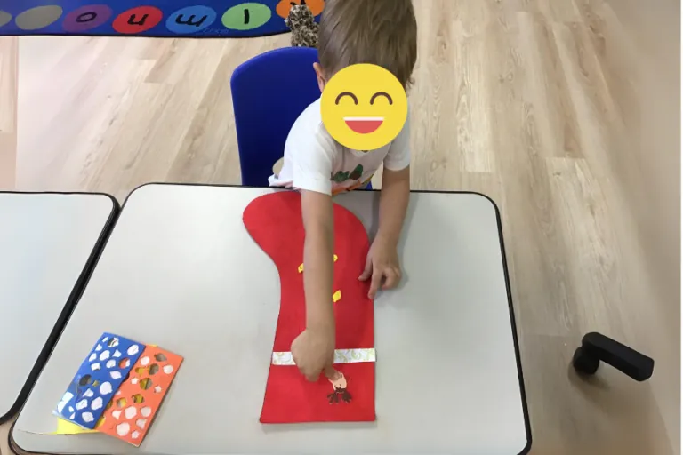 Child doing a hands-on math activity at a table