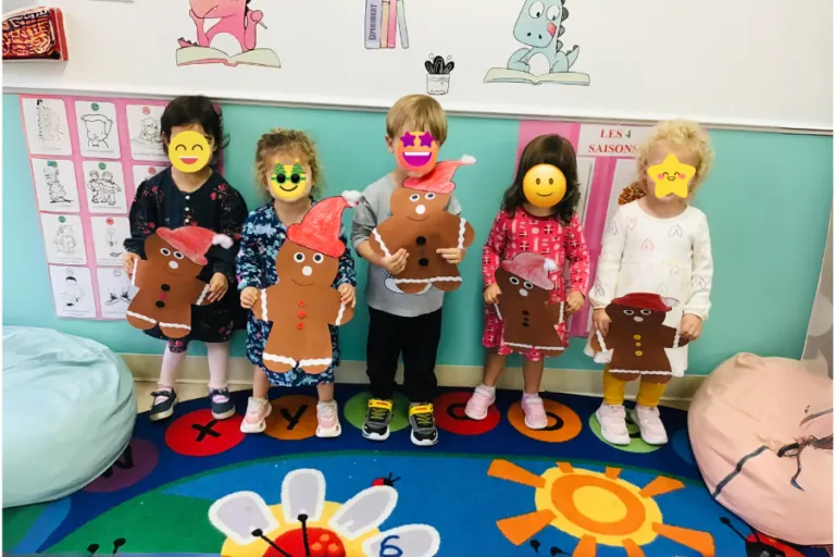 Children showing their crafts on the classroom rug