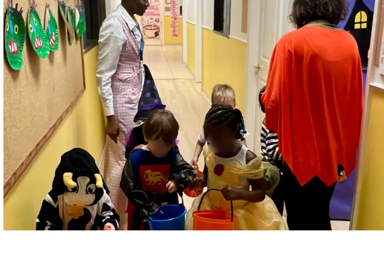 Children in costumes parading down the hallway